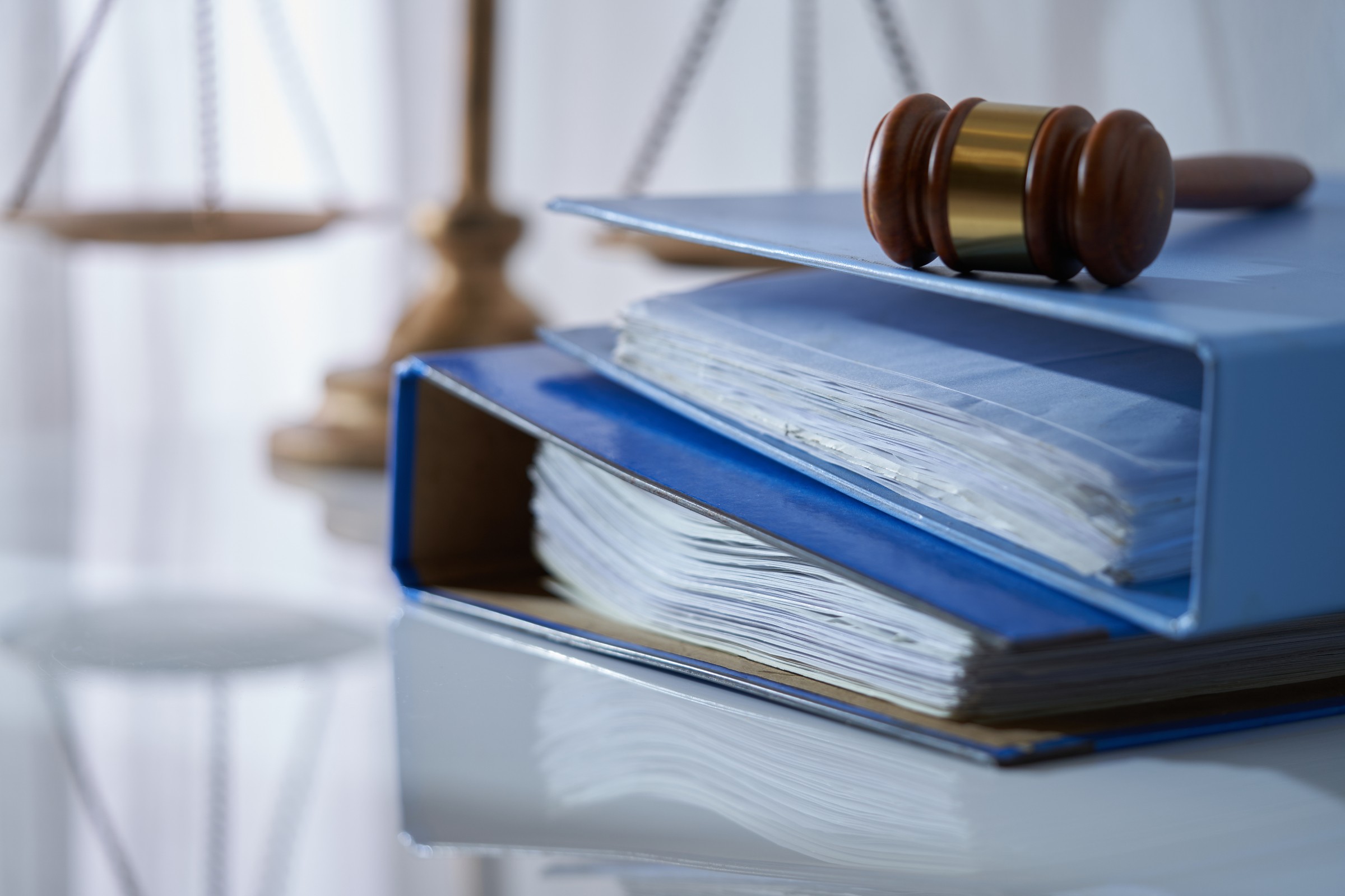Legal documents and a referee's gavel on a table