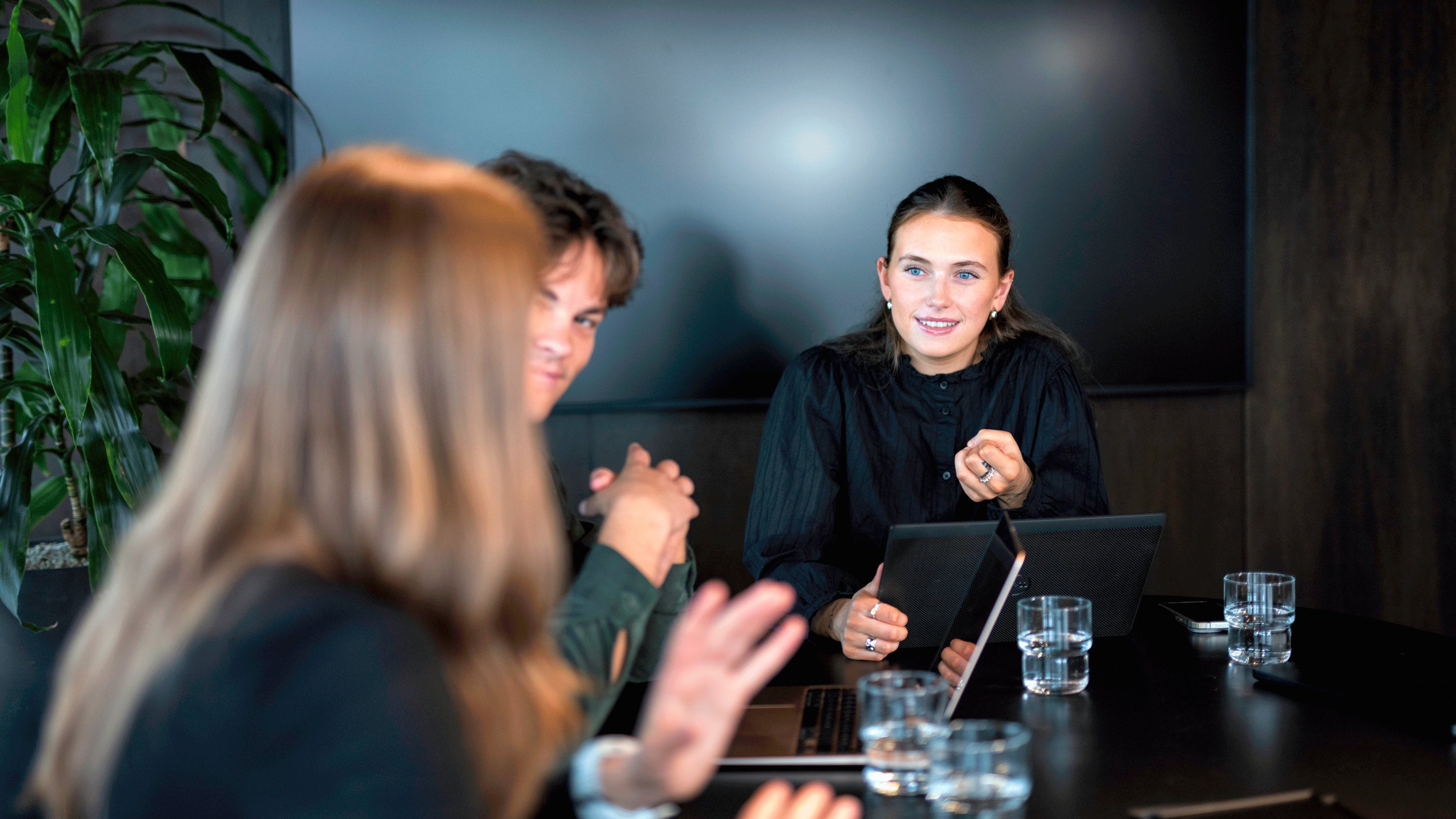 A group of union representatives or employees in a meeting are actively discussing, symbolizing co-determination and cooperation in the workplace.