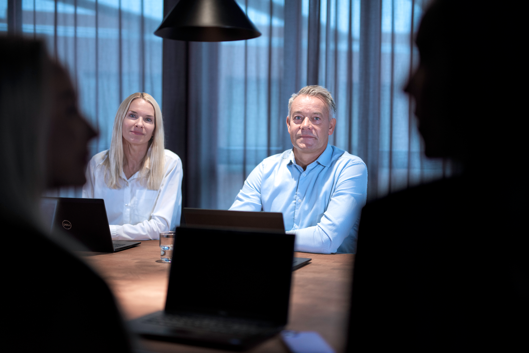 Four people in a meeting room
