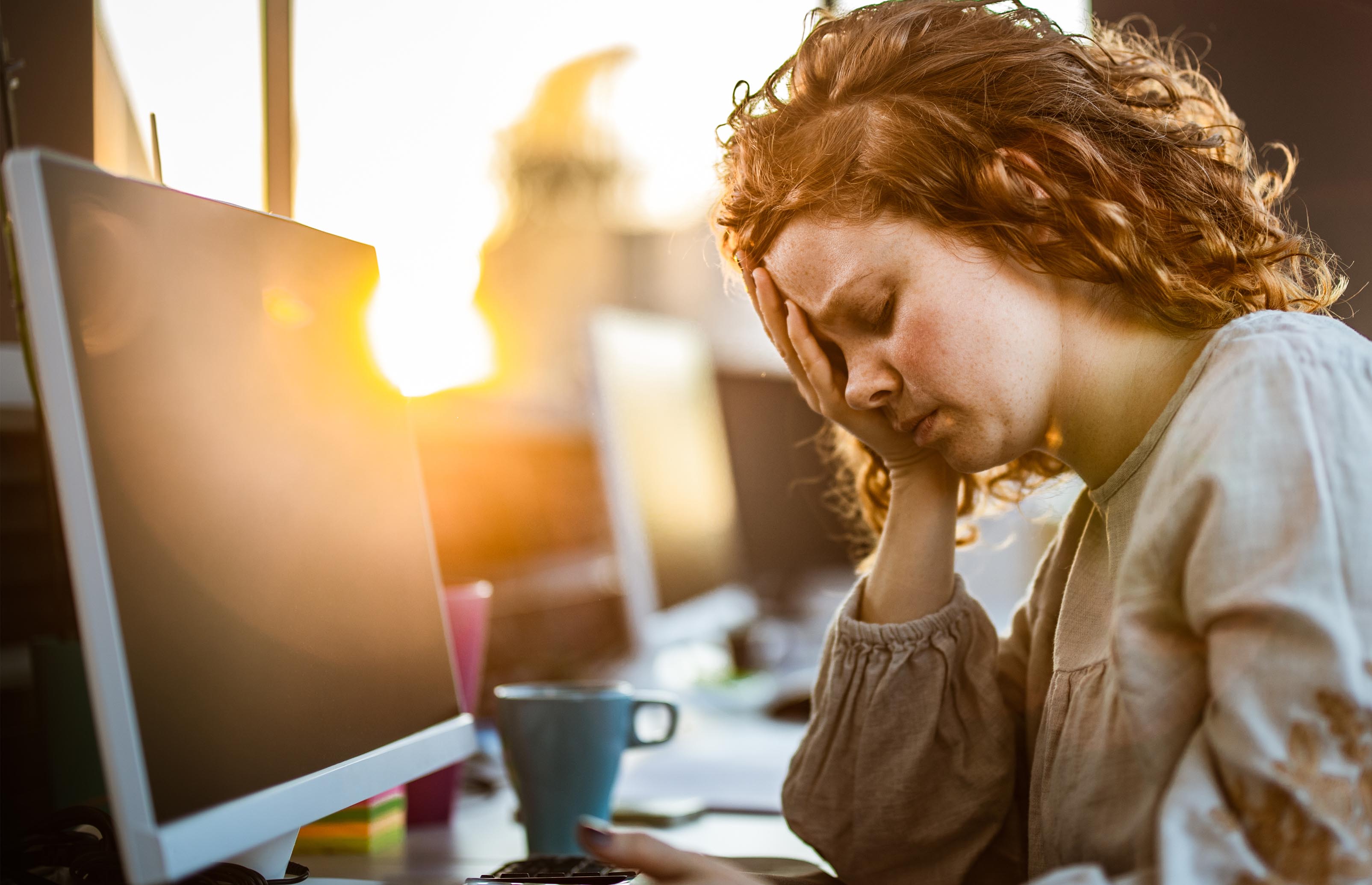 Stressed employee at computer assessing their rights in the event of dismissal