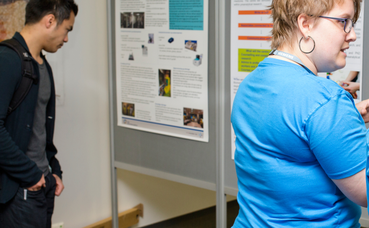 Participants at a congress looking at a poster exhibition.