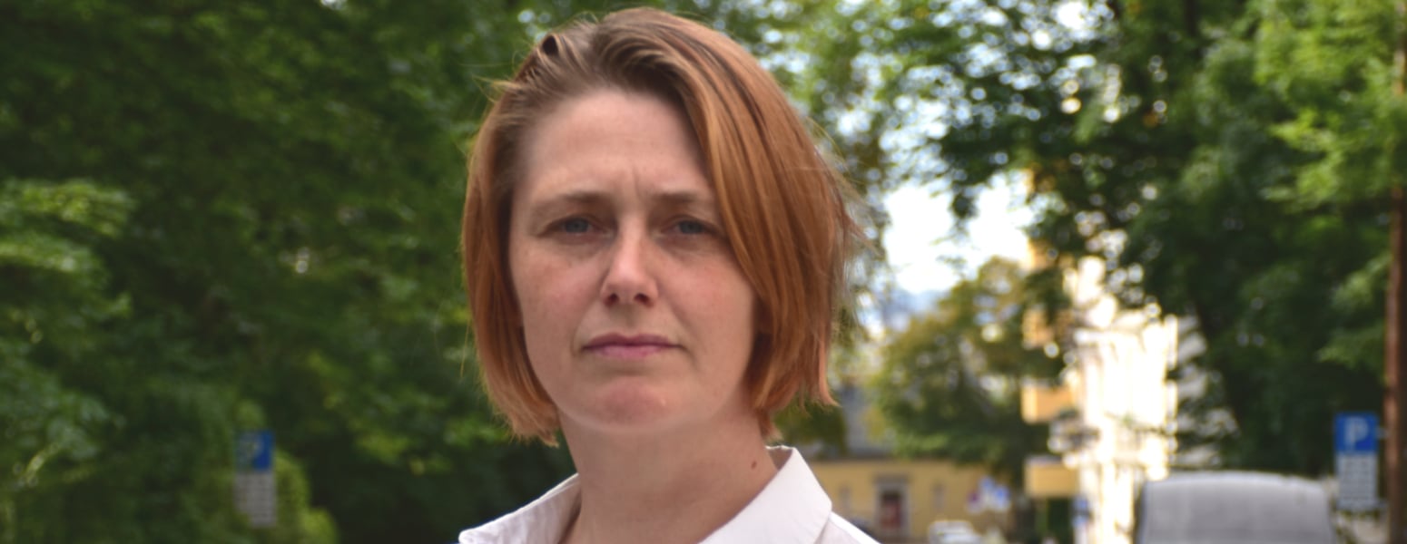 Portrait of woman, with cars and trees in the background