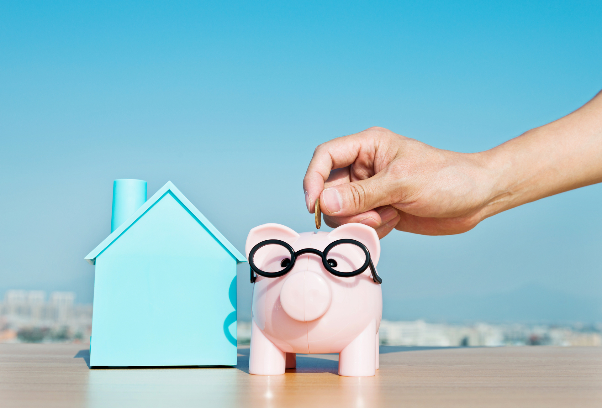 Illustration of someone putting money in a piggy bank