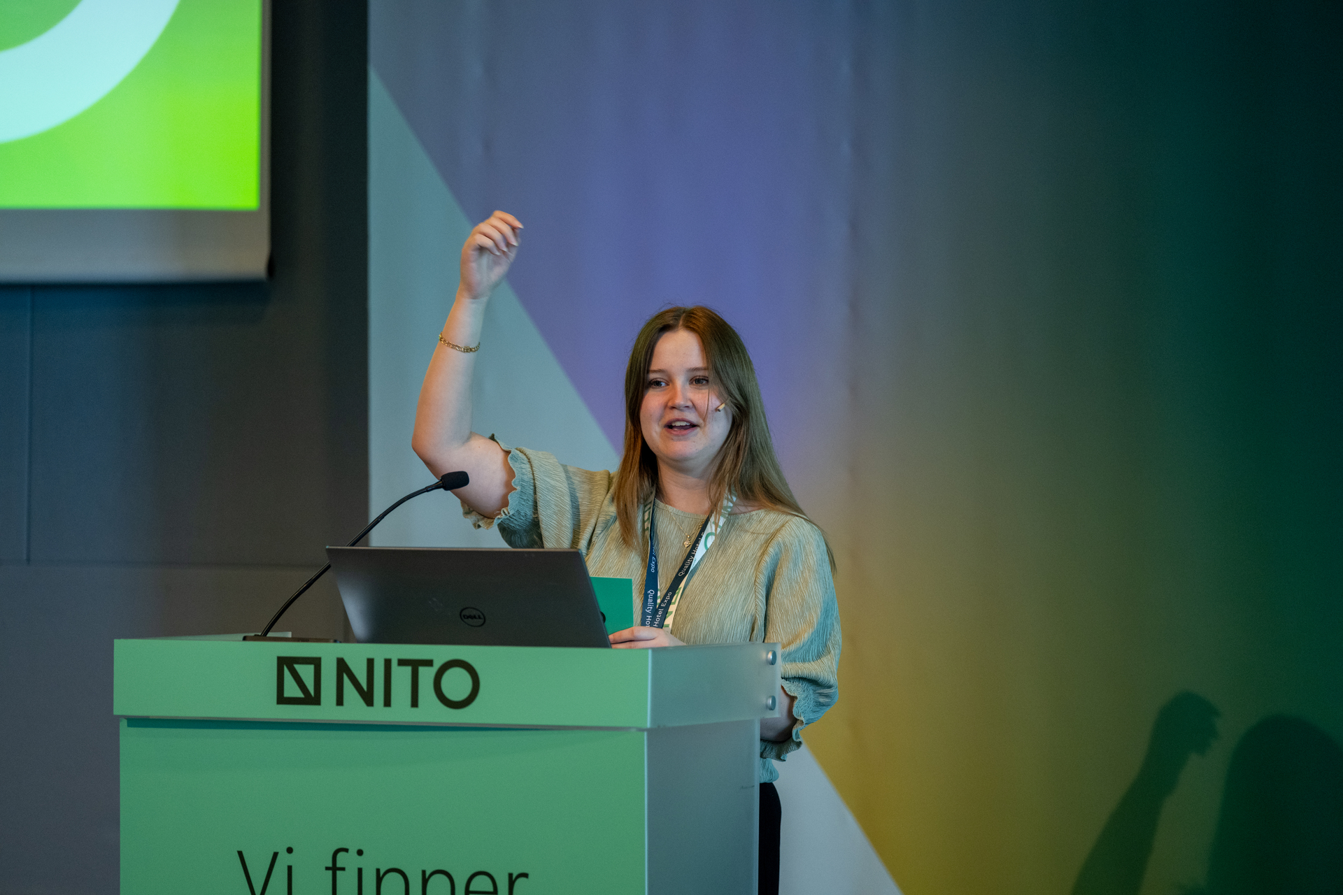 Engaged young woman standing on a pulpit in a conference hall.