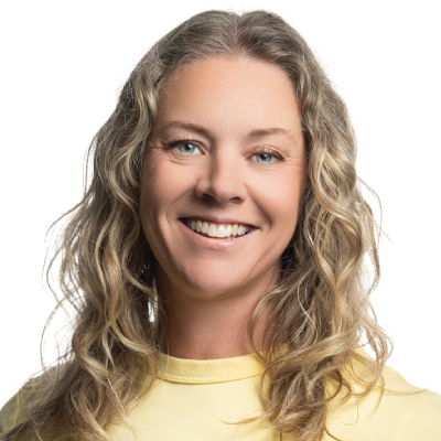 Smiling woman with long blonde hair and a yellow sweater.