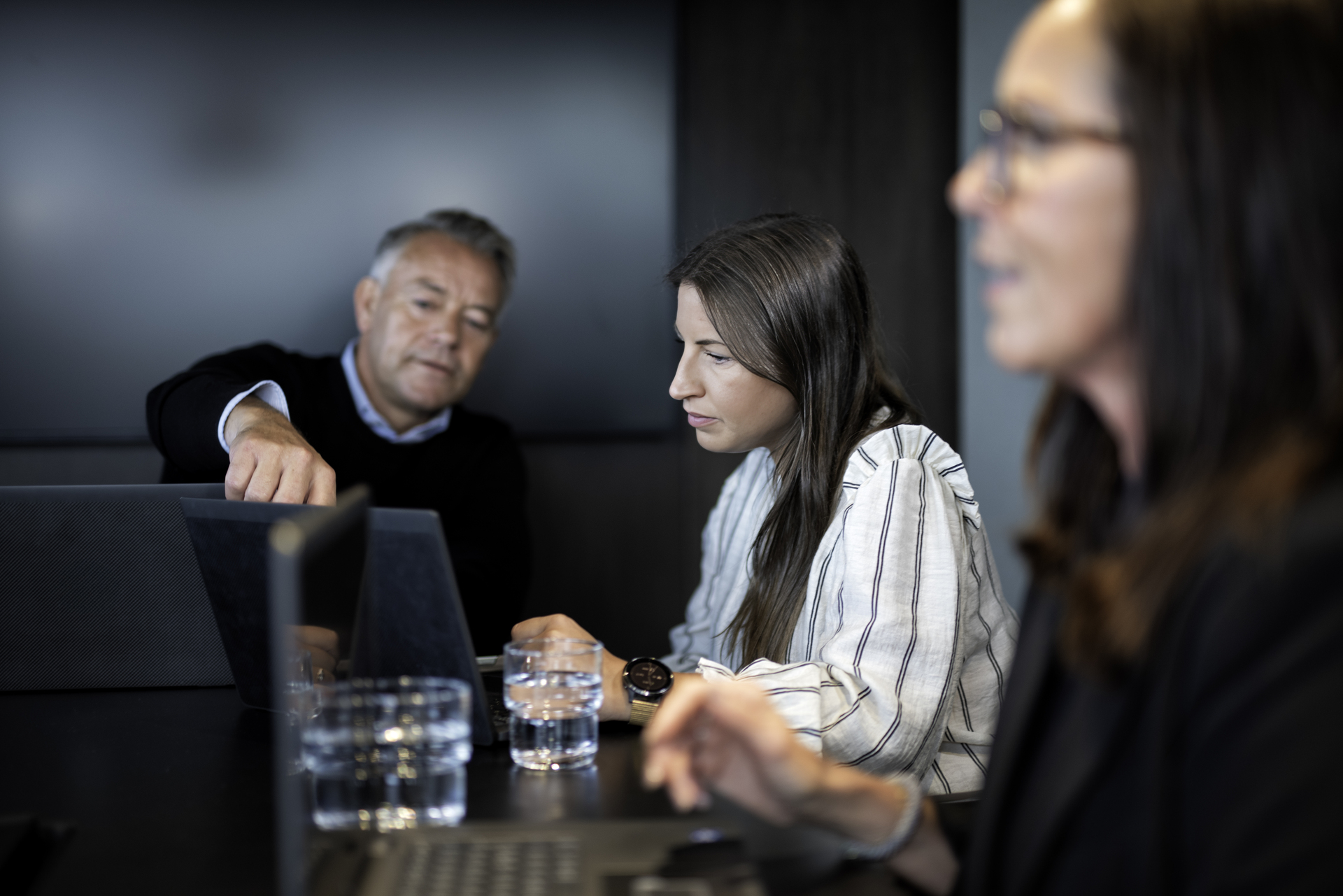 Employees discuss in one meeting room