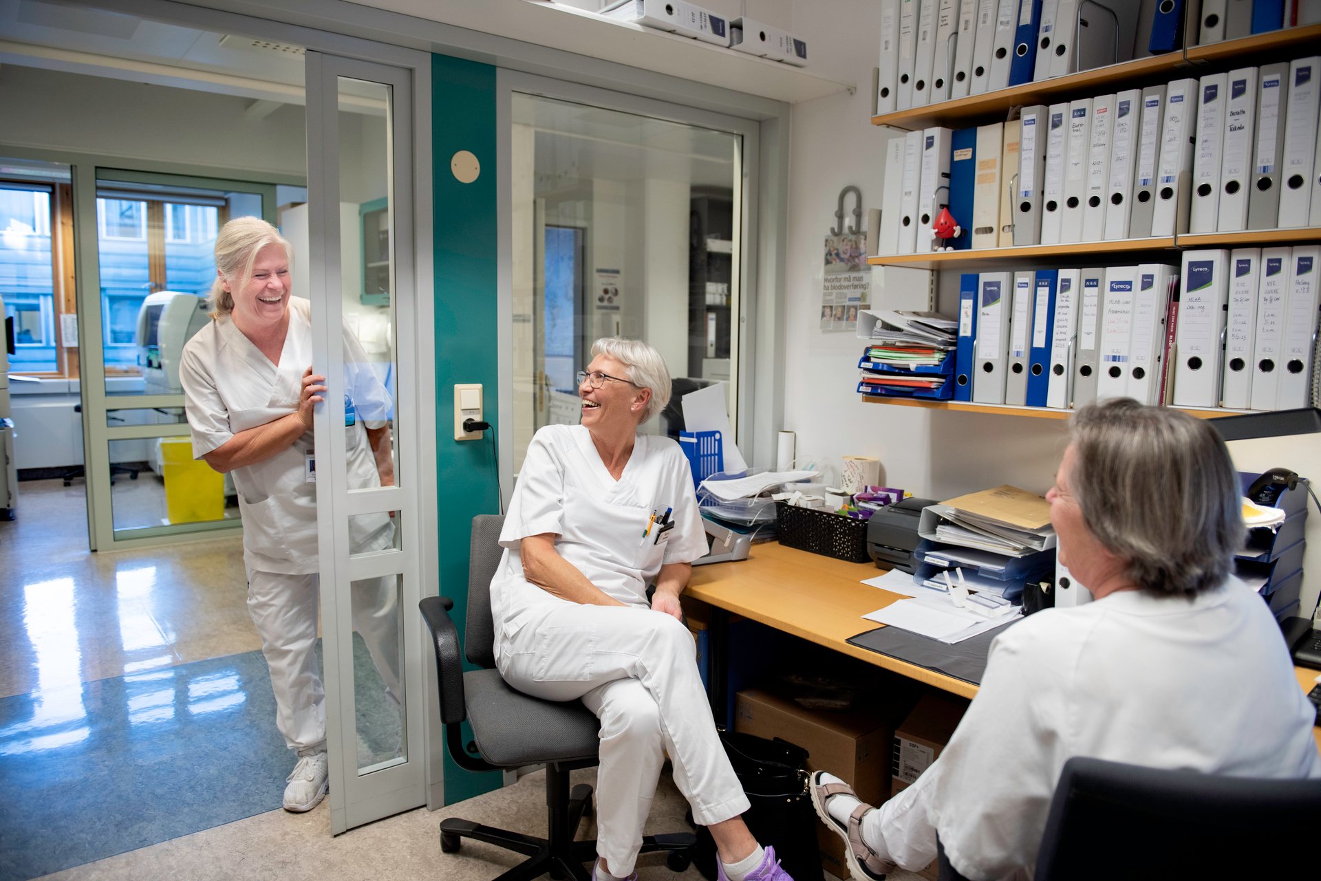 Biomedical laboratory technicians sitting inside an office