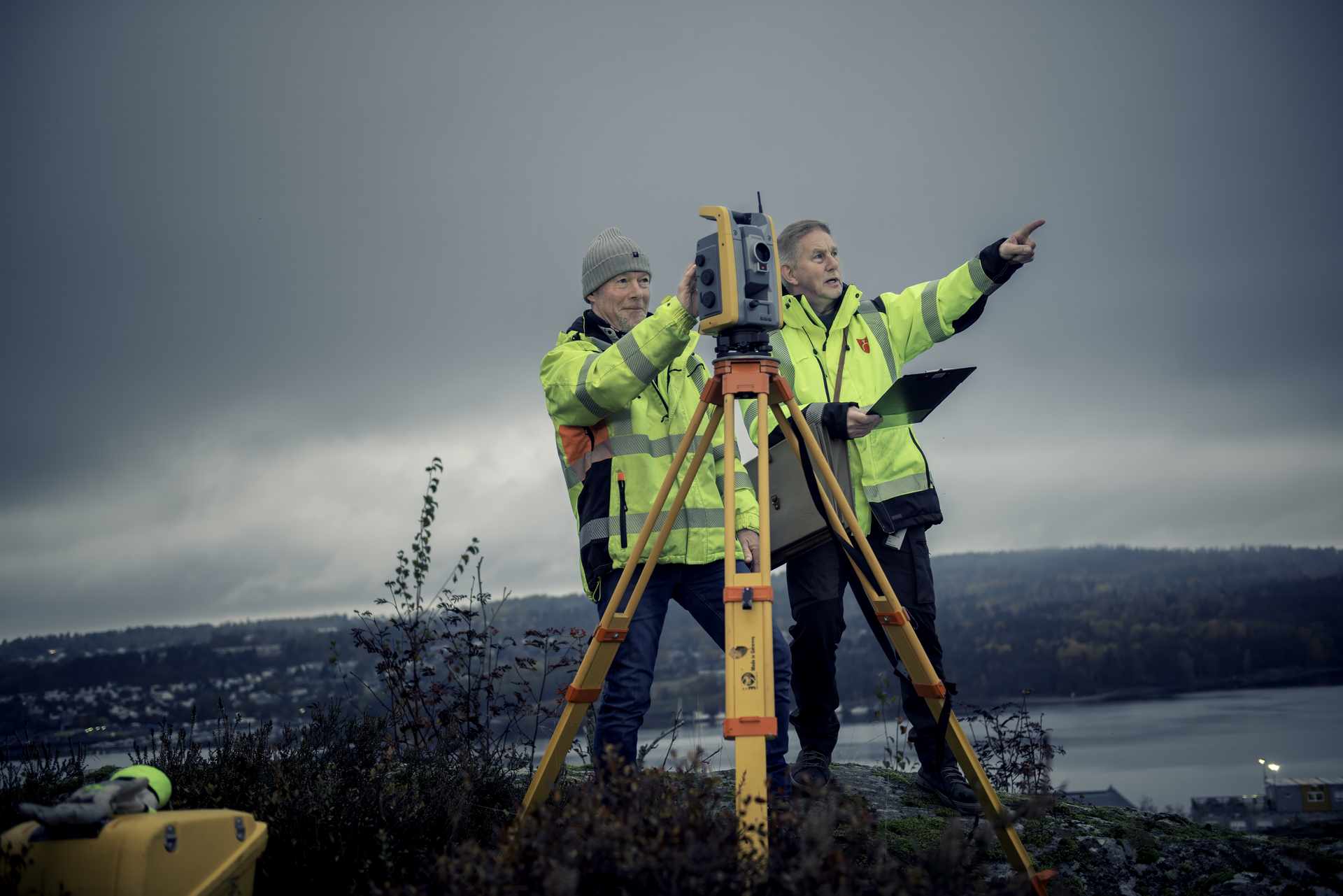 Surveyors pointing to something on the horizon