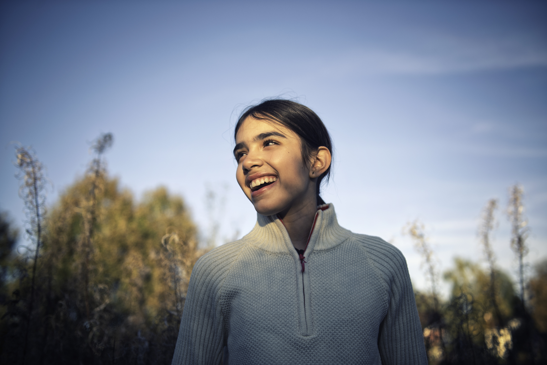 Young girl smiling and looking to the side