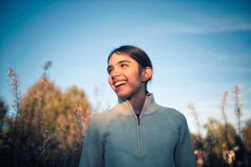 Young girl smiling and looking to the side