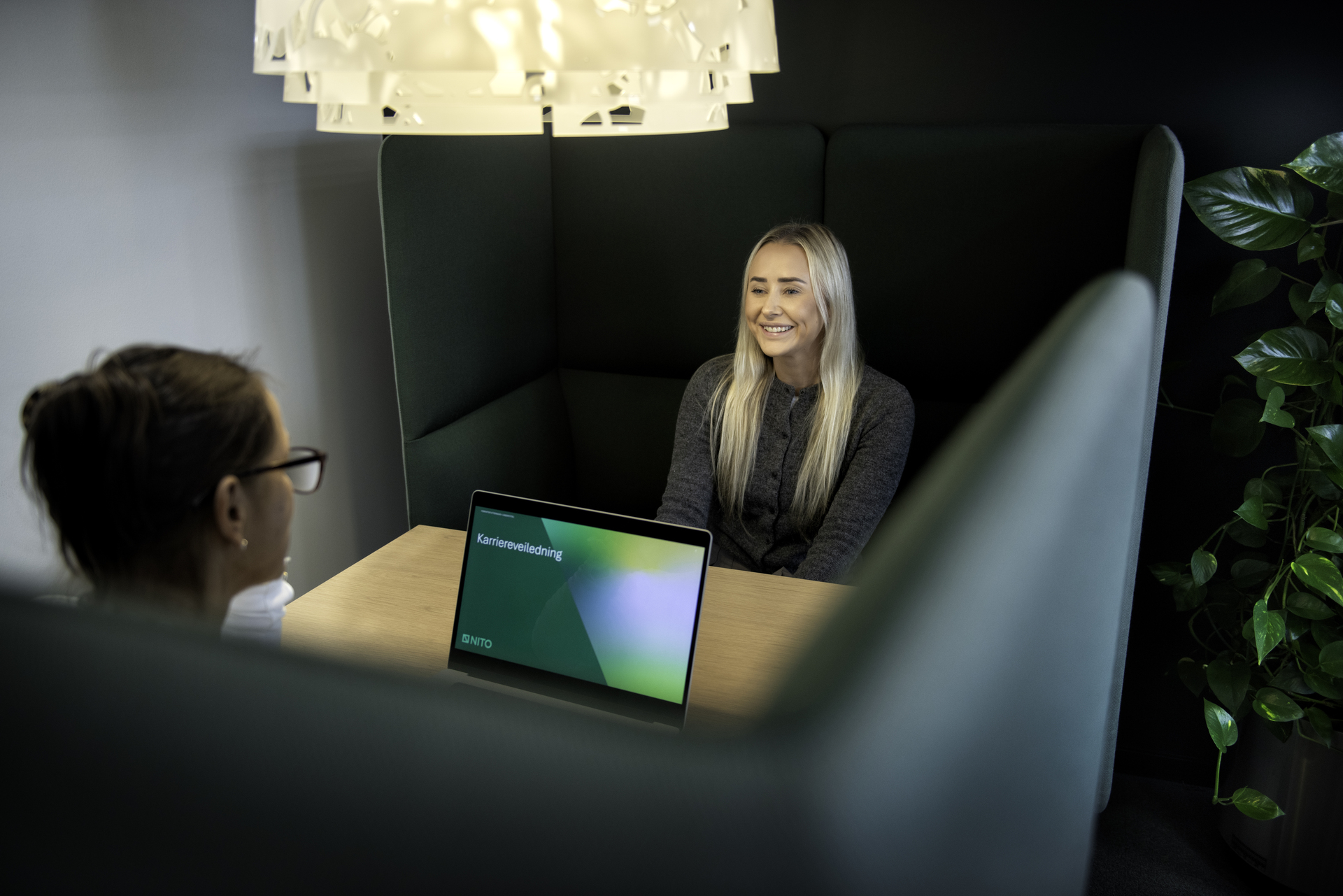 Two ladies sit on opposite sides of the table and talk