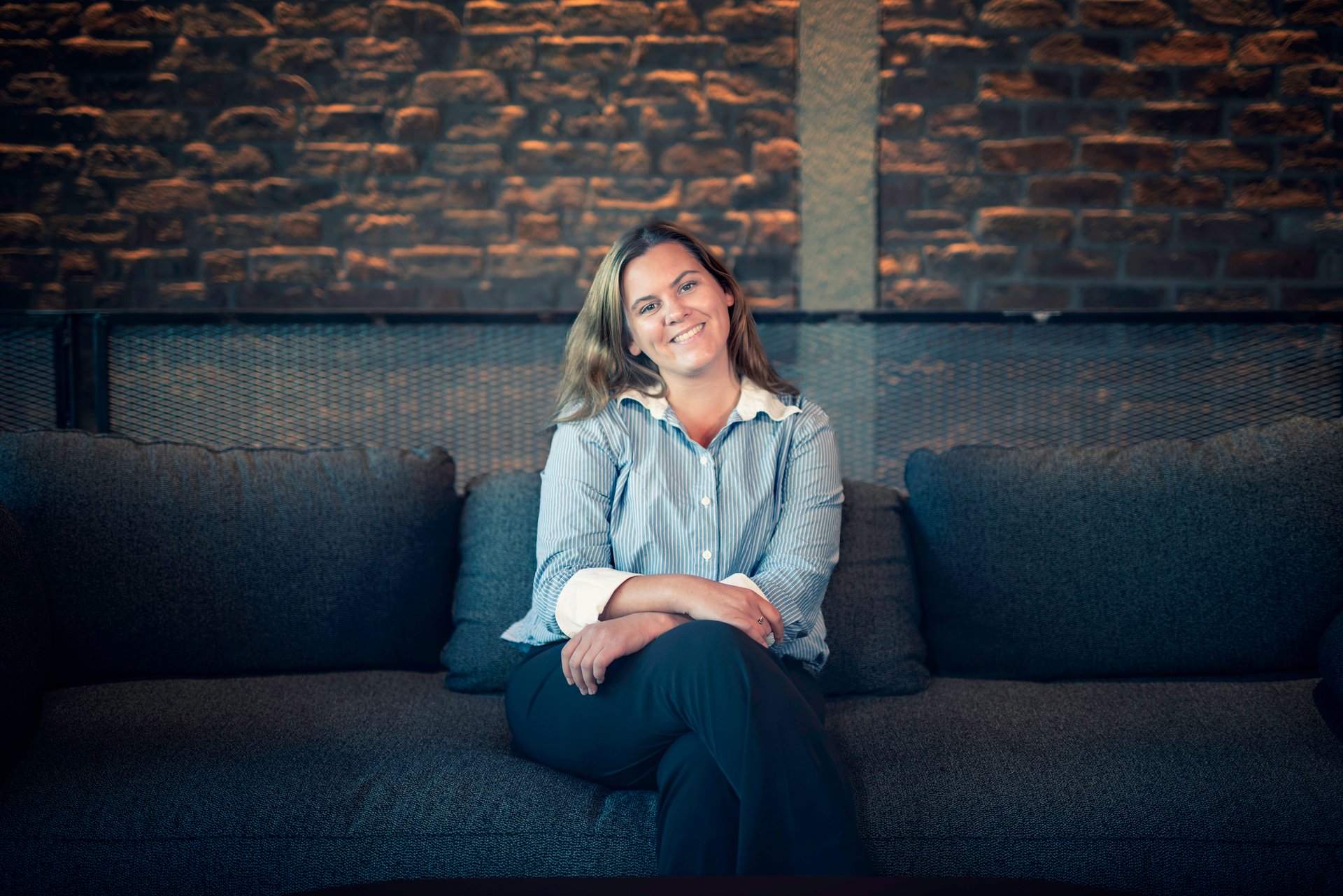 Young smiling lady sitting on a sofa