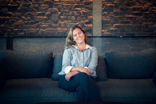 Young smiling lady sitting on a sofa